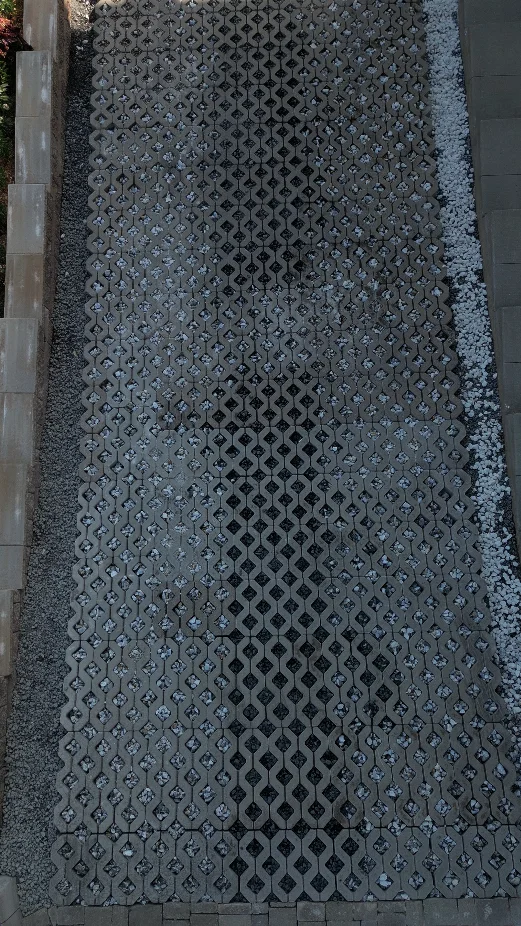 Permeable concrete grid driveway filled with decorative stone